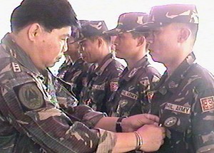 LtGen. Pedro Ike Inserto pinning a medal to a 14IB soldier