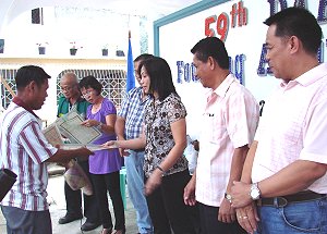 Daram mayor Lou Astorga distributing land titles to famers