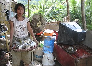 A resident gathering soiled belongings because of typhoon FERIA